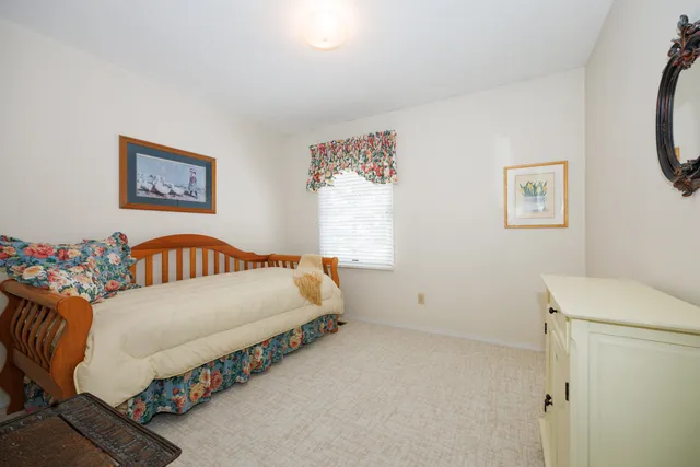 a bedroom with bed and a window