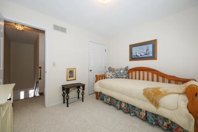 a bedroom with a bed and a table in it