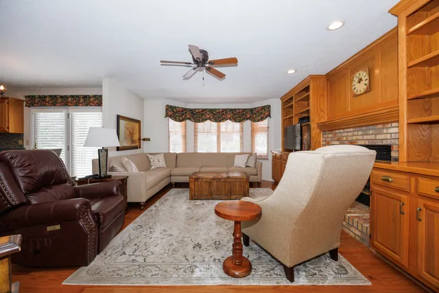 a living room with furniture ceiling fan and a rug