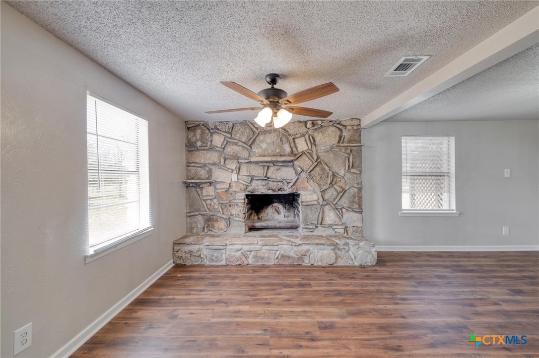 4978 Sparta Road Belton, TX 76513 - Photo 7 of 32 an empty room with fireplace and windows