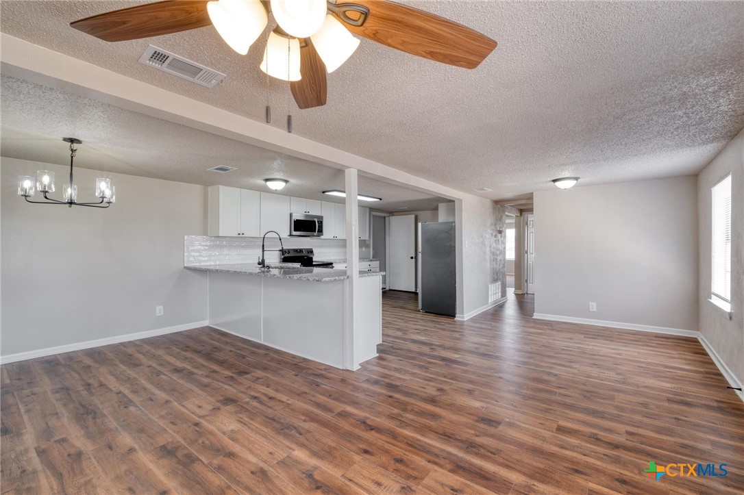 4978 Sparta Road Belton, TX 76513 - Photo 8 of 32 a view of a kitchen with a sink and wooden floor