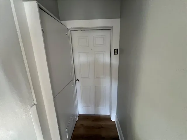a view of an entryway with wooden floor