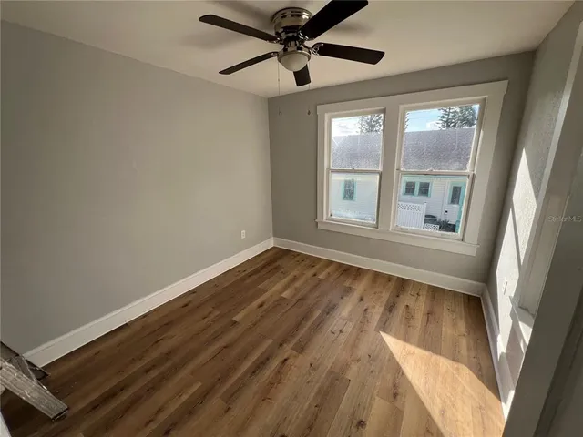 wooden floor in an empty room with a window