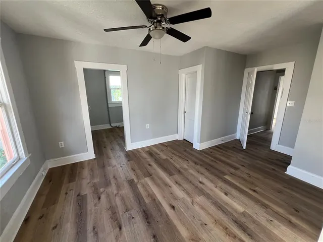 a kitchen with granite countertop a sink and wooden floor