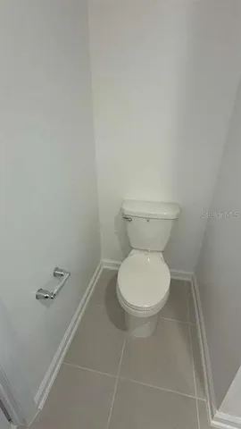 a white toilet sitting next to a white sink