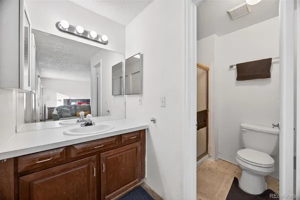 a bathroom with a toilet a sink and a mirror
