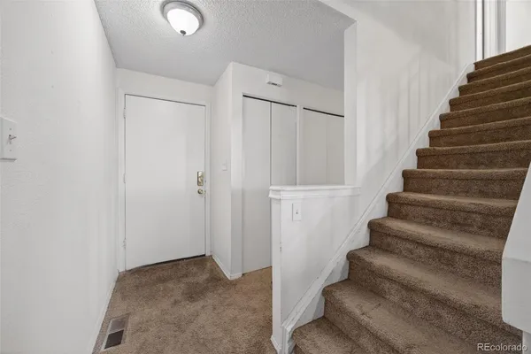 a view of staircase with white walls