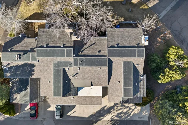 an aerial view of a house with a yard