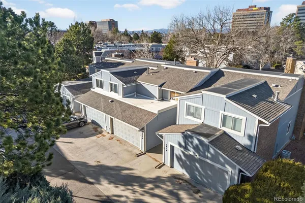 a view of a house with roof deck and tall buildings