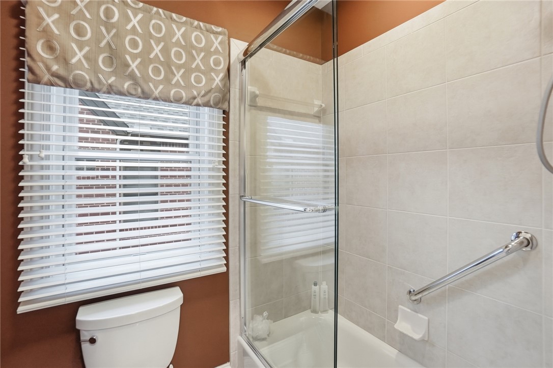 159 Rue Marseille Kettering, OH 45429 - Photo 24 of 52 This bathroom features a sleek glass-enclosed tub shower combination and a window for natural light.