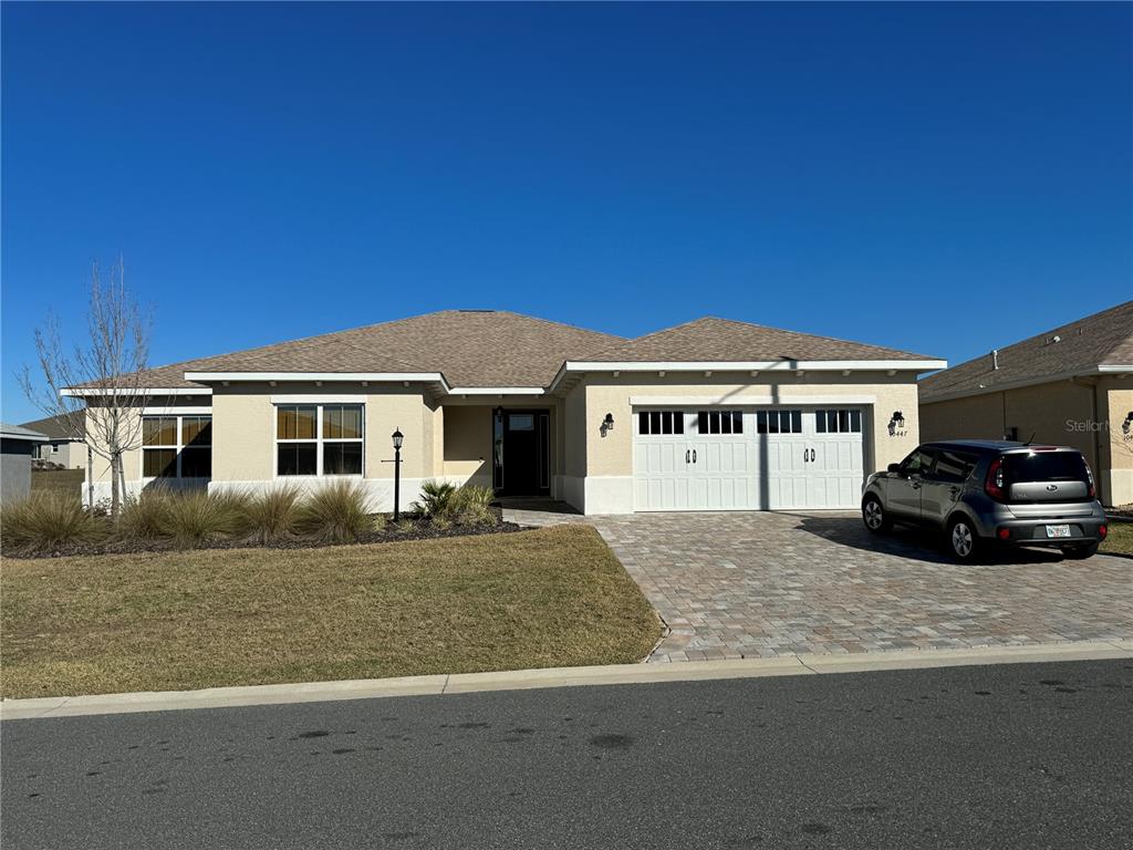 a view of house with a yard