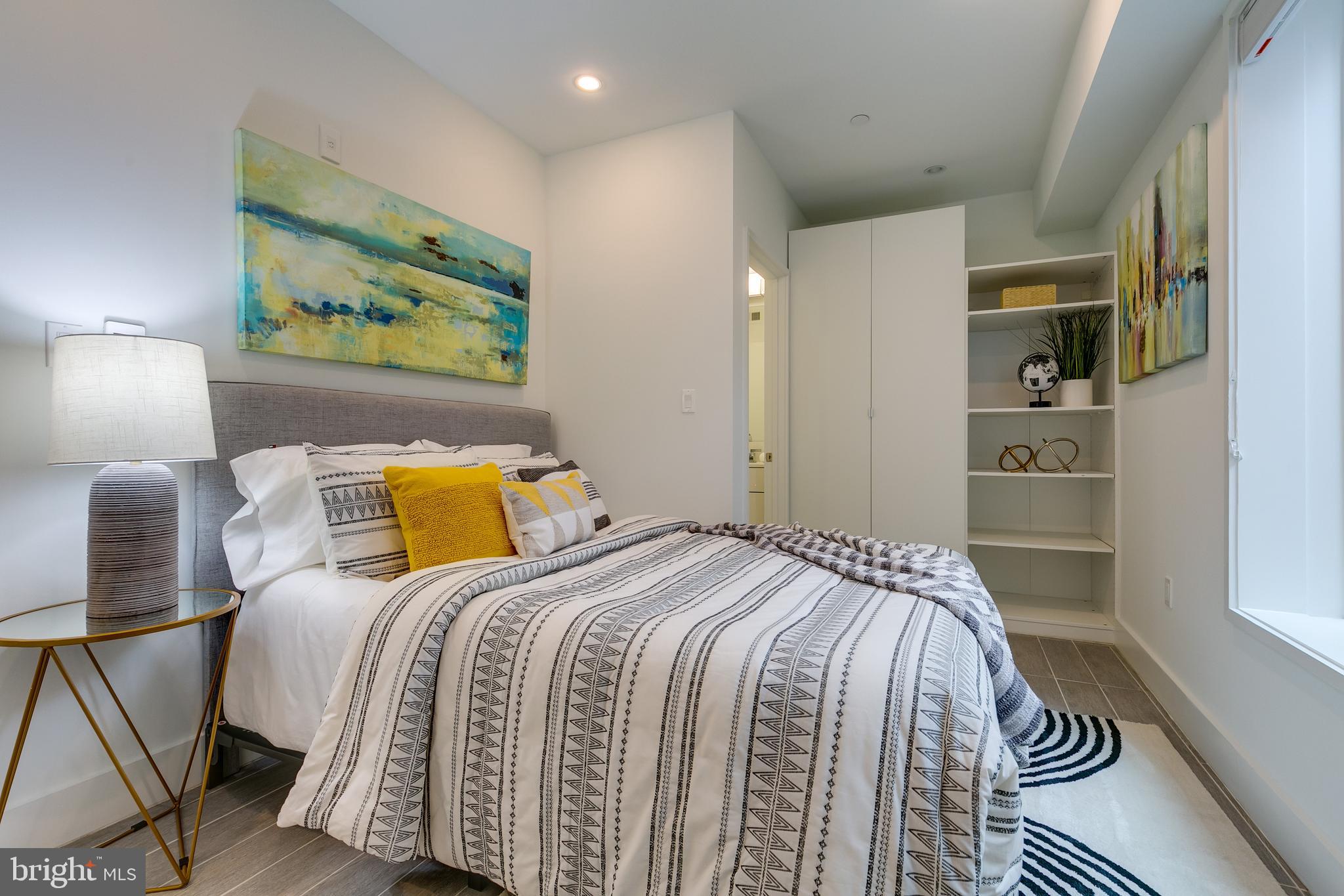 4529 MacArthur Boulevard Northwest, Unit 3 Washington, DC 20007 - Photo 15 of 50 a bedroom with a bed and painting on the wall