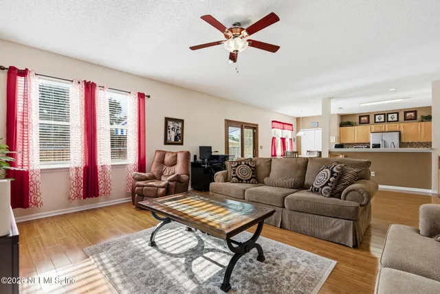 a kitchen with stainless steel appliances granite countertop a stove top oven a sink dishwasher and cabinets with wooden floor