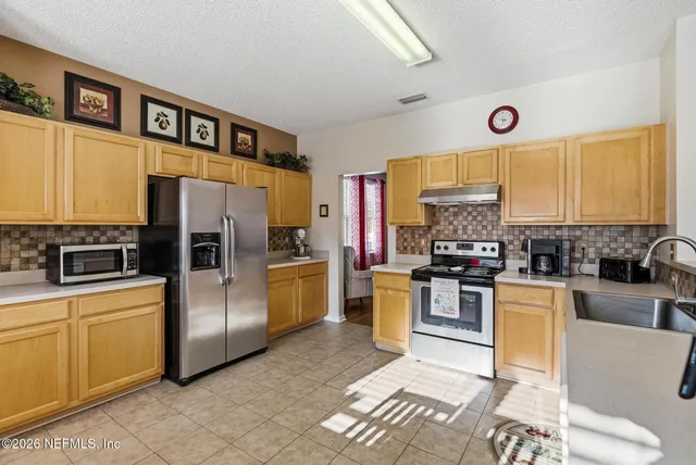 a living room with furniture a rug and a bookshelf
