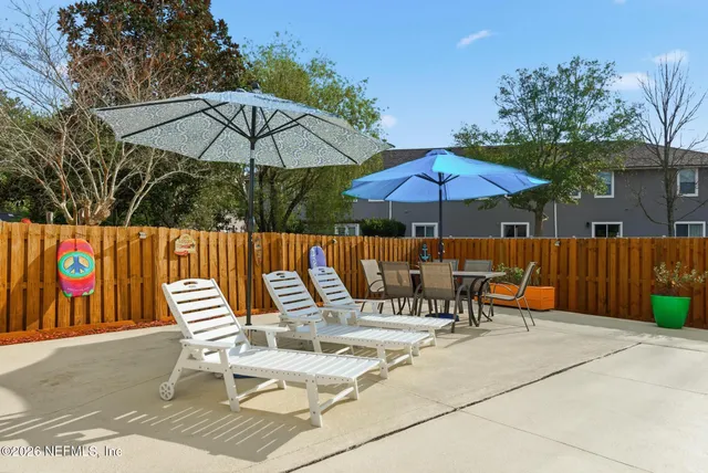 a living room with furniture a rug and a window