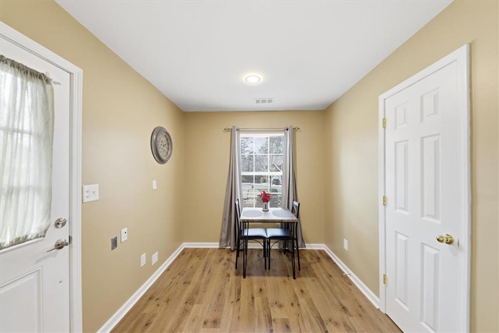 1318 Reece Road Woodstock, GA 30188 - Photo 11 of 40 a view of a room with wooden floor and a window