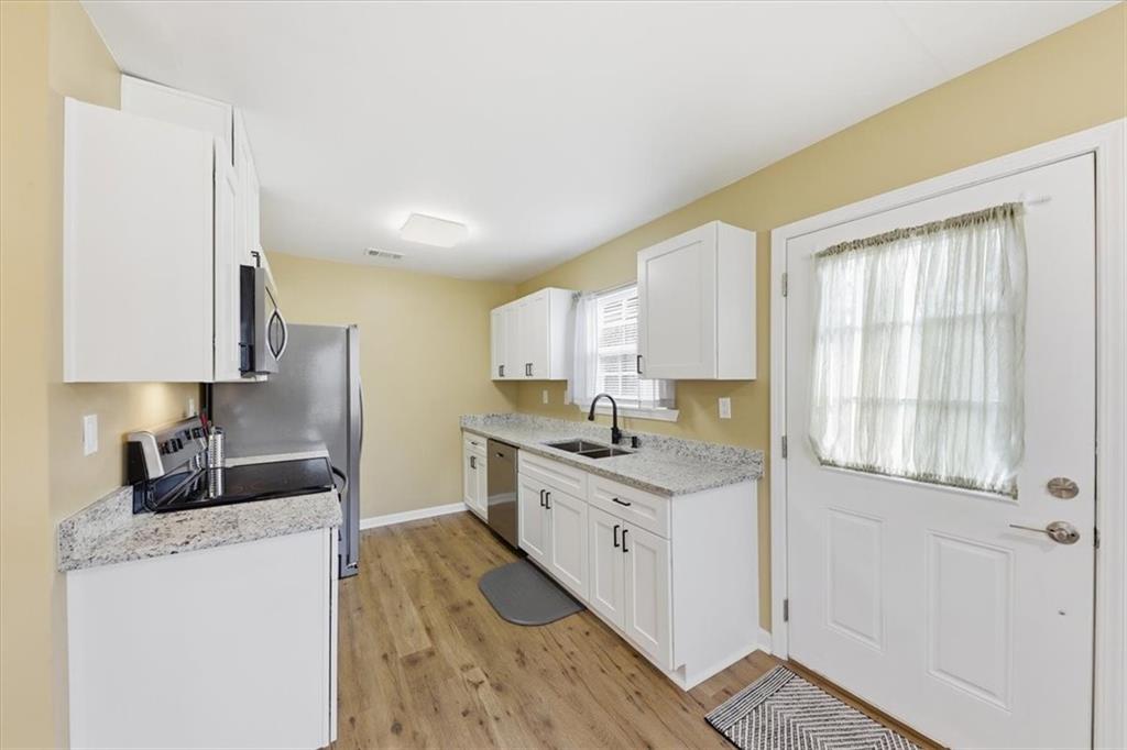 1318 Reece Road Woodstock, GA 30188 - Photo 13 of 40 a kitchen with a sink stove and cabinets