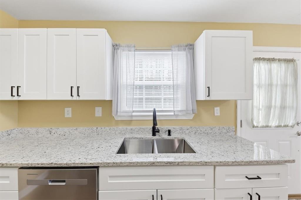 1318 Reece Road Woodstock, GA 30188 - Photo 15 of 40 a kitchen with granite countertop a sink and a granite counter tops