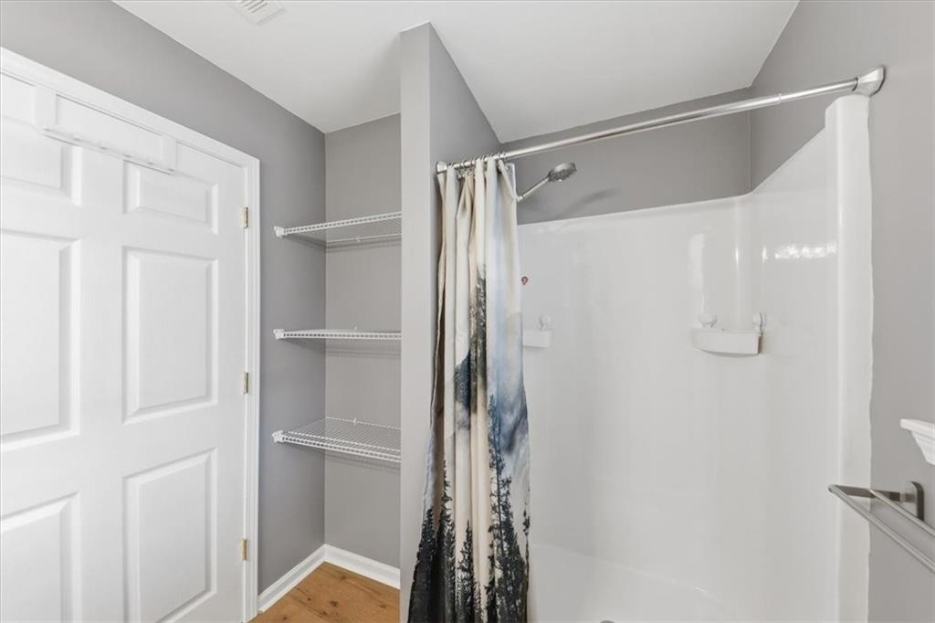 1318 Reece Road Woodstock, GA 30188 - Photo 19 of 40 a view of walk in closet with empty racks
