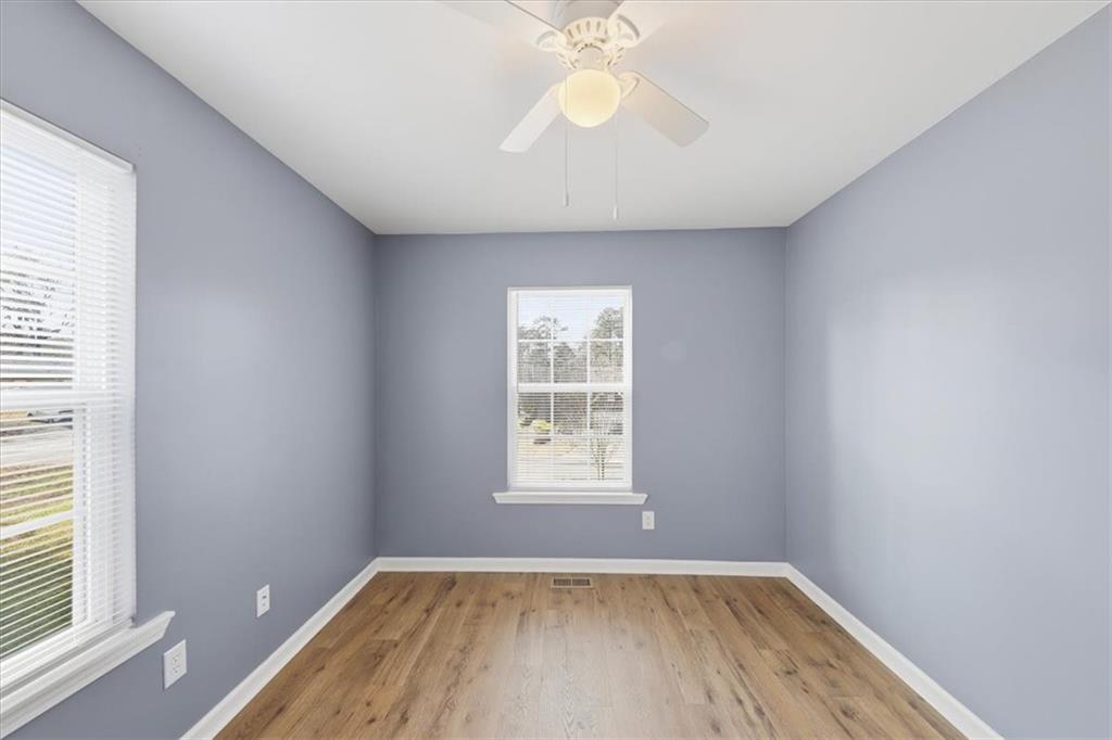 1318 Reece Road Woodstock, GA 30188 - Photo 21 of 40 wooden floor in an empty room with a window