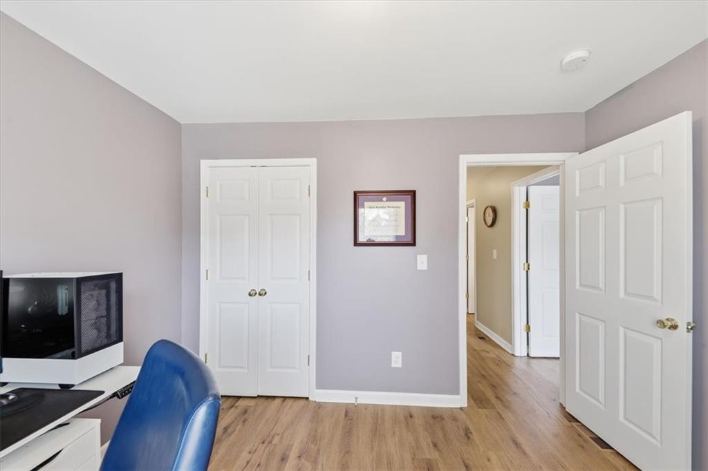 1318 Reece Road Woodstock, GA 30188 - Photo 24 of 40 a view of a workspace with wooden floor and bathroom view
