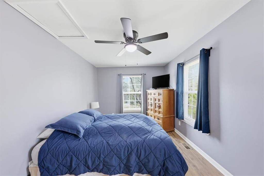 1318 Reece Road Woodstock, GA 30188 - Photo 28 of 40 a bed sitting in a spacious bedroom next to a window