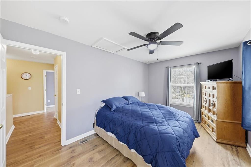 1318 Reece Road Woodstock, GA 30188 - Photo 29 of 40 a bedroom with a bed and a flat screen tv