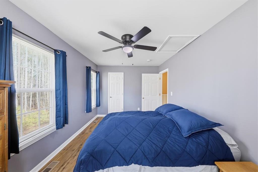 1318 Reece Road Woodstock, GA 30188 - Photo 30 of 40 a bedroom with a bed and a large window with a flat screen tv