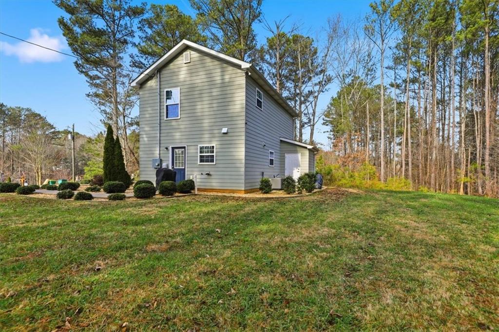 1318 Reece Road Woodstock, GA 30188 - Photo 31 of 40 a view of a house with a yard