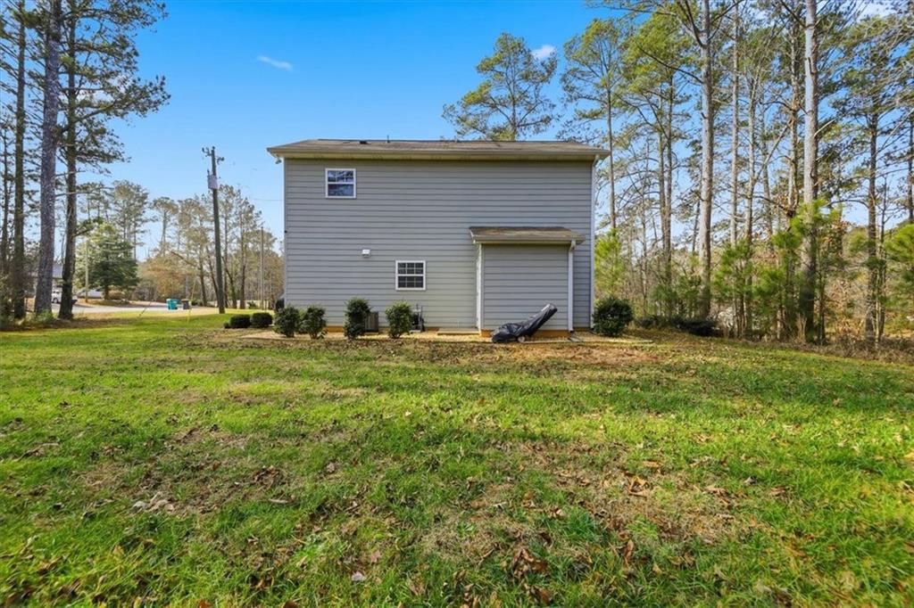 1318 Reece Road Woodstock, GA 30188 - Photo 33 of 40 a view of a house with a yard