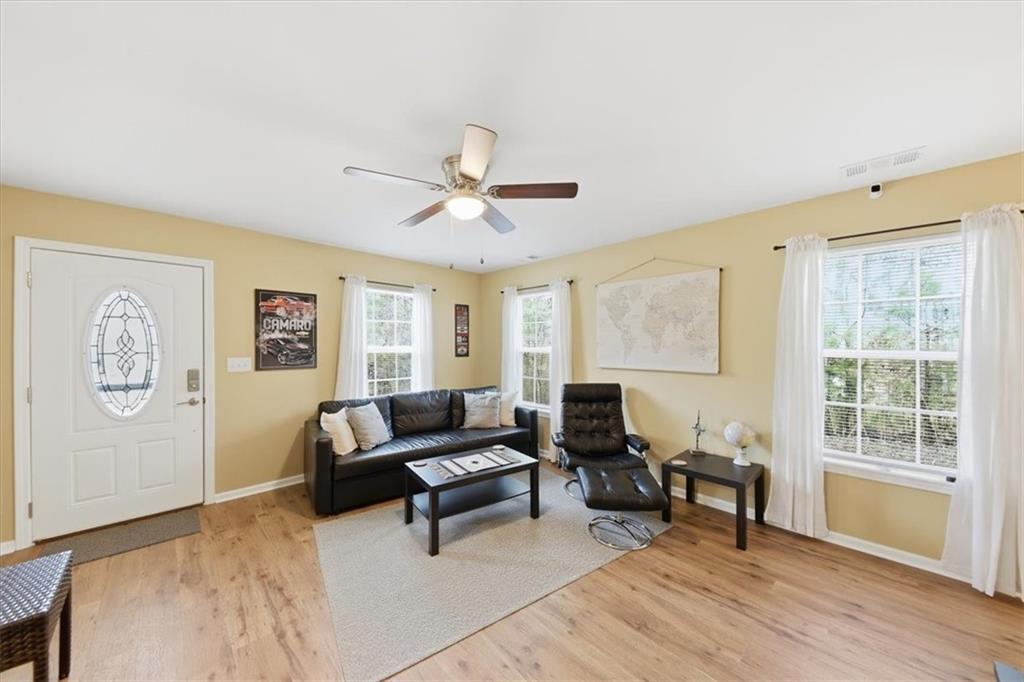 1318 Reece Road Woodstock, GA 30188 - Photo 8 of 40 a living room with furniture and a window