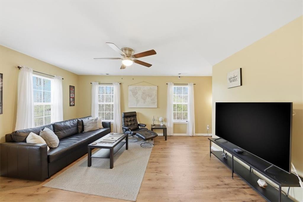 1318 Reece Road Woodstock, GA 30188 - Photo 9 of 40 a living room with furniture and a flat screen tv