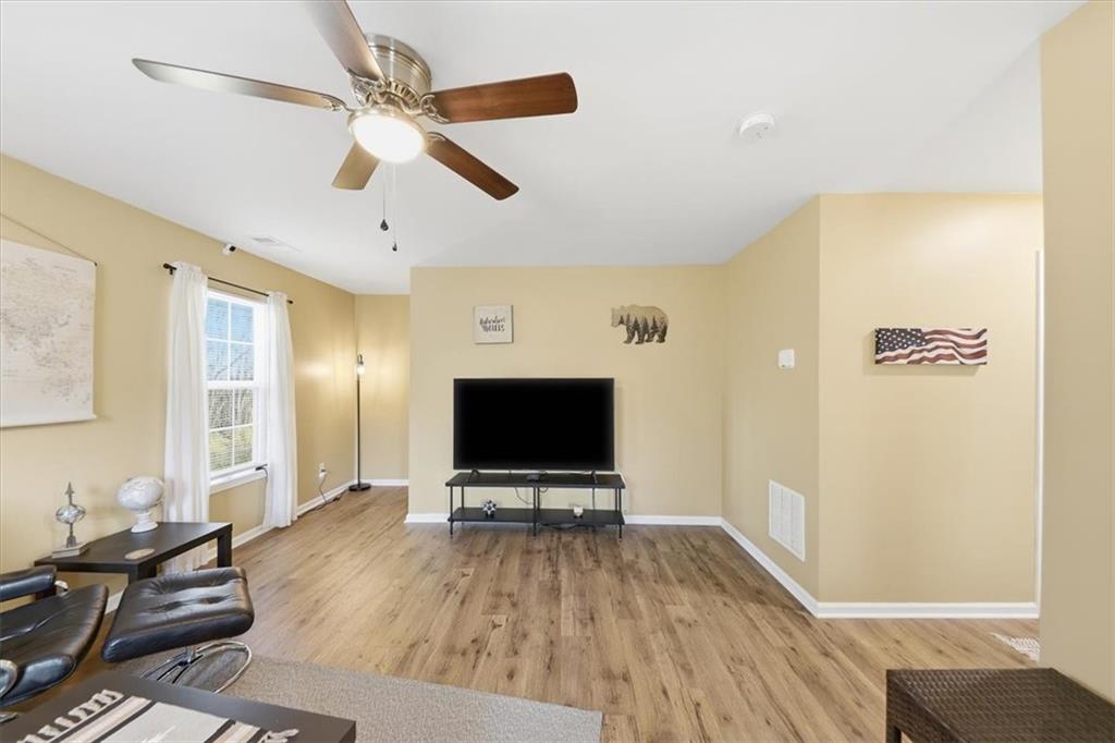 1318 Reece Road Woodstock, GA 30188 - Photo 10 of 40 a living room with furniture and a flat screen tv