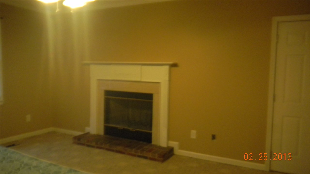 18 Dunn Street Coats, NC 27521 - Photo 2 of 5 a view of empty room with a fireplace