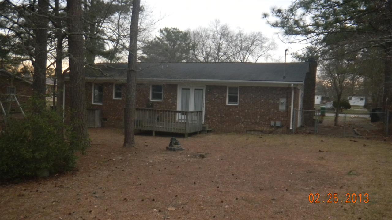 18 Dunn Street Coats, NC 27521 - Photo 3 of 5 a backyard of a house with table and chairs