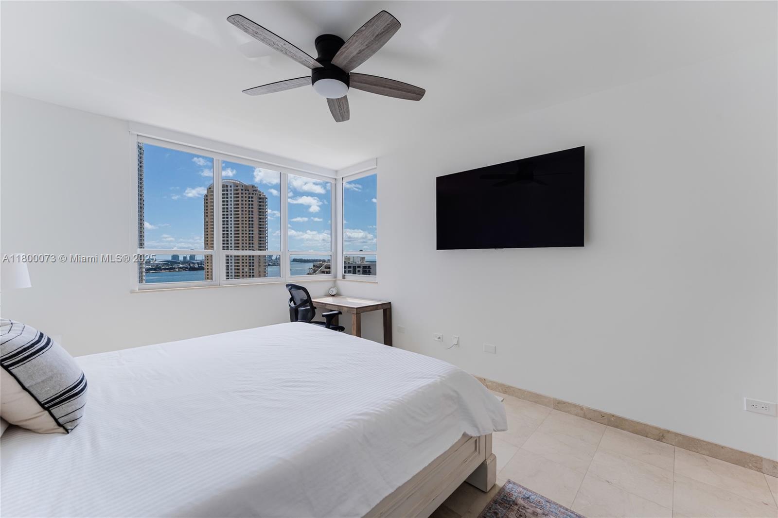 801 Brickell Key Boulevard, Unit 1911 Miami, FL 33131 - Photo 11 of 21 a bedroom with a large bed and a flat screen tv