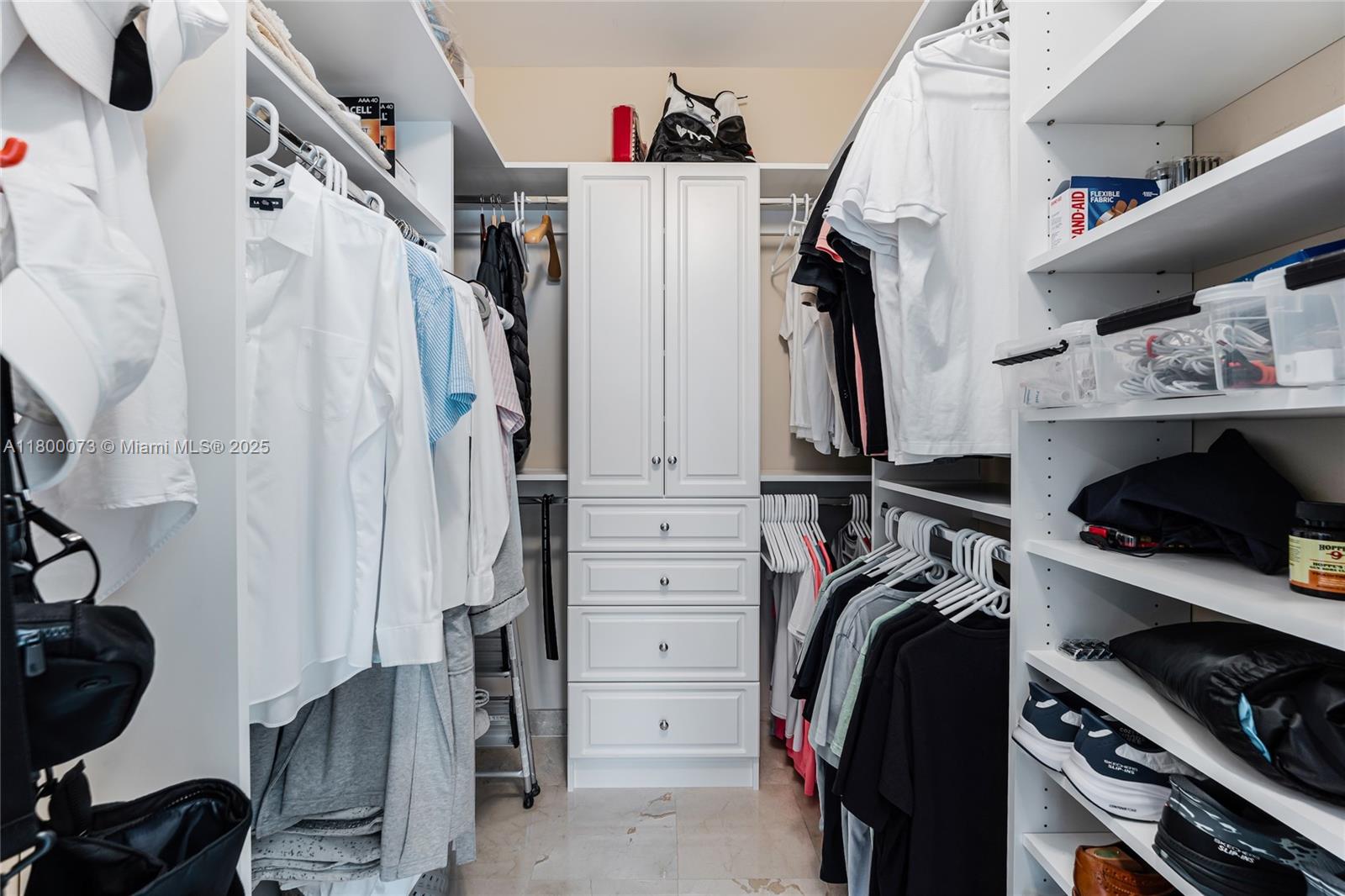 801 Brickell Key Boulevard, Unit 1911 Miami, FL 33131 - Photo 12 of 21 a view of walk in closet with clothes and shoes