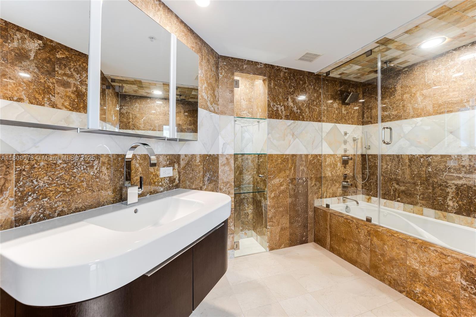 801 Brickell Key Boulevard, Unit 1911 Miami, FL 33131 - Photo 13 of 21 a bathroom with a sink and a bathtub