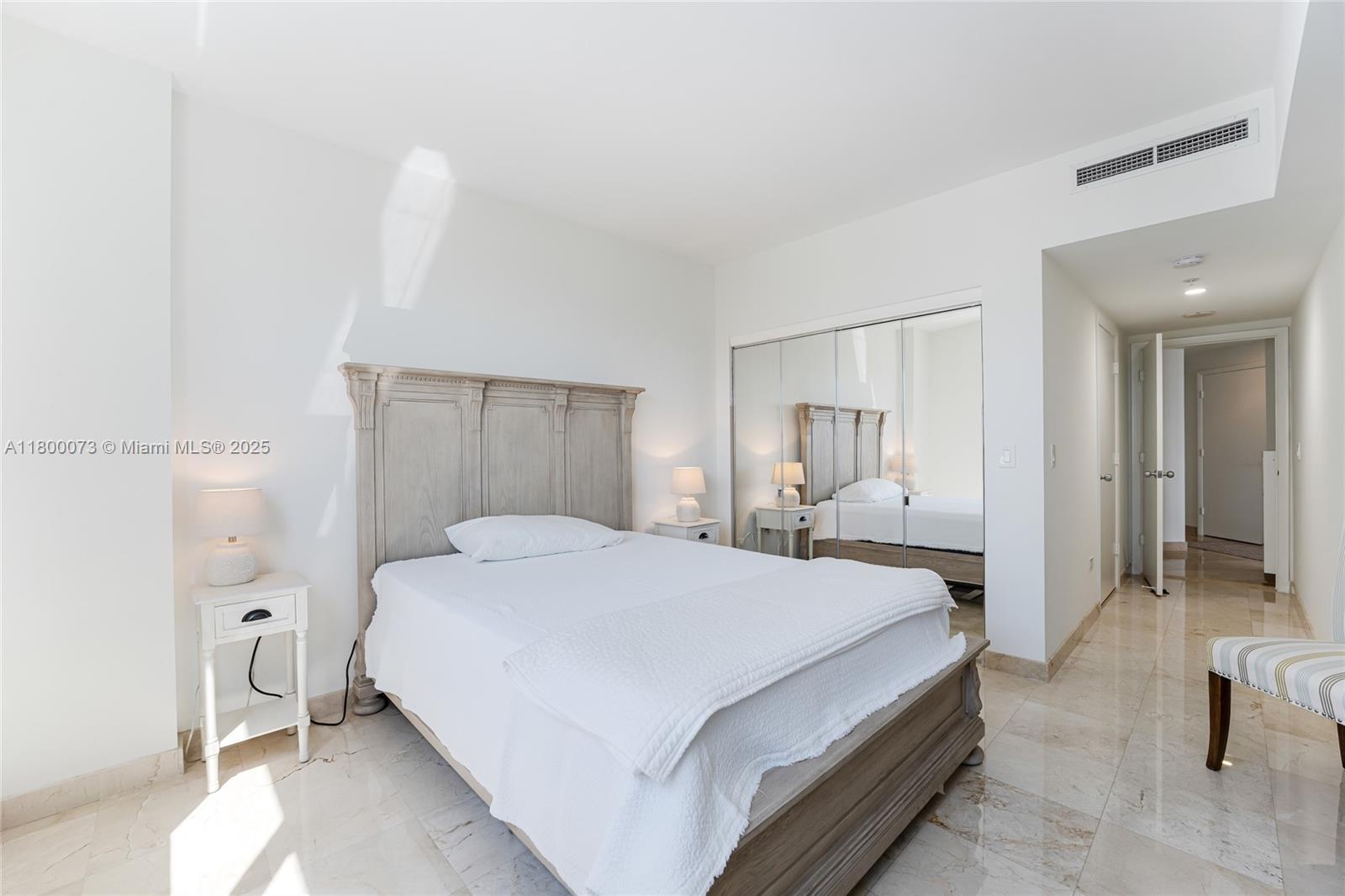 801 Brickell Key Boulevard, Unit 1911 Miami, FL 33131 - Photo 14 of 21 a spacious bedroom with a bed and a couch