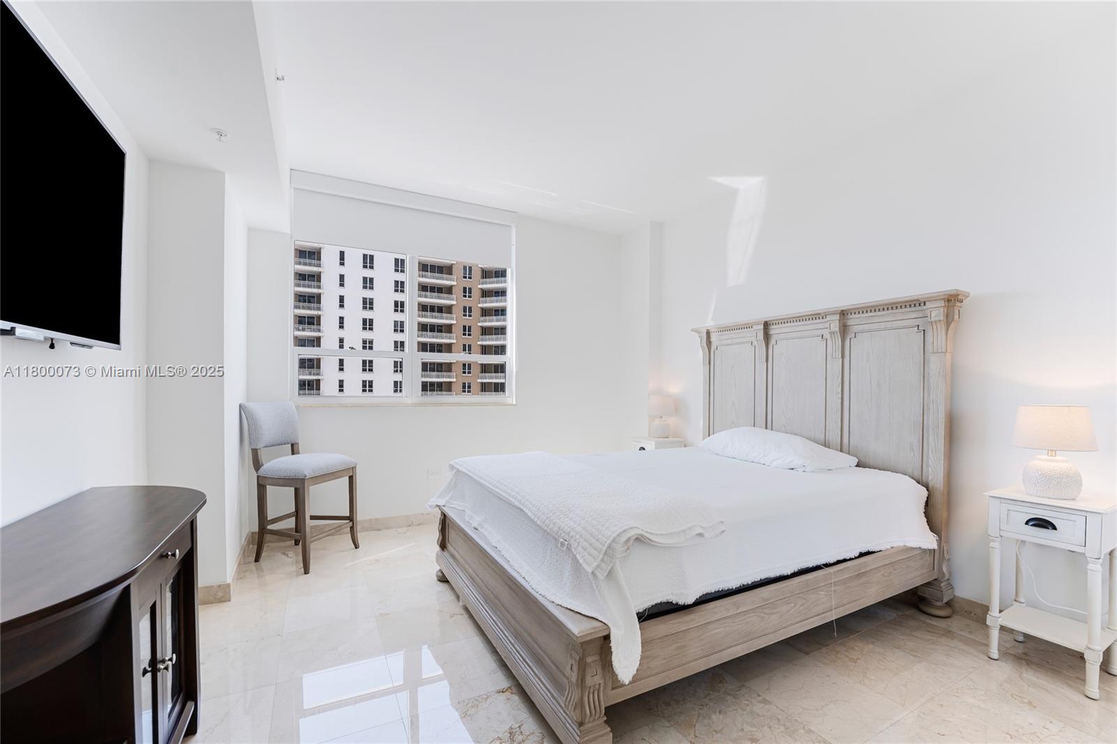 801 Brickell Key Boulevard, Unit 1911 Miami, FL 33131 - Photo 15 of 21 a bed sitting in a bedroom and a flat screen tv