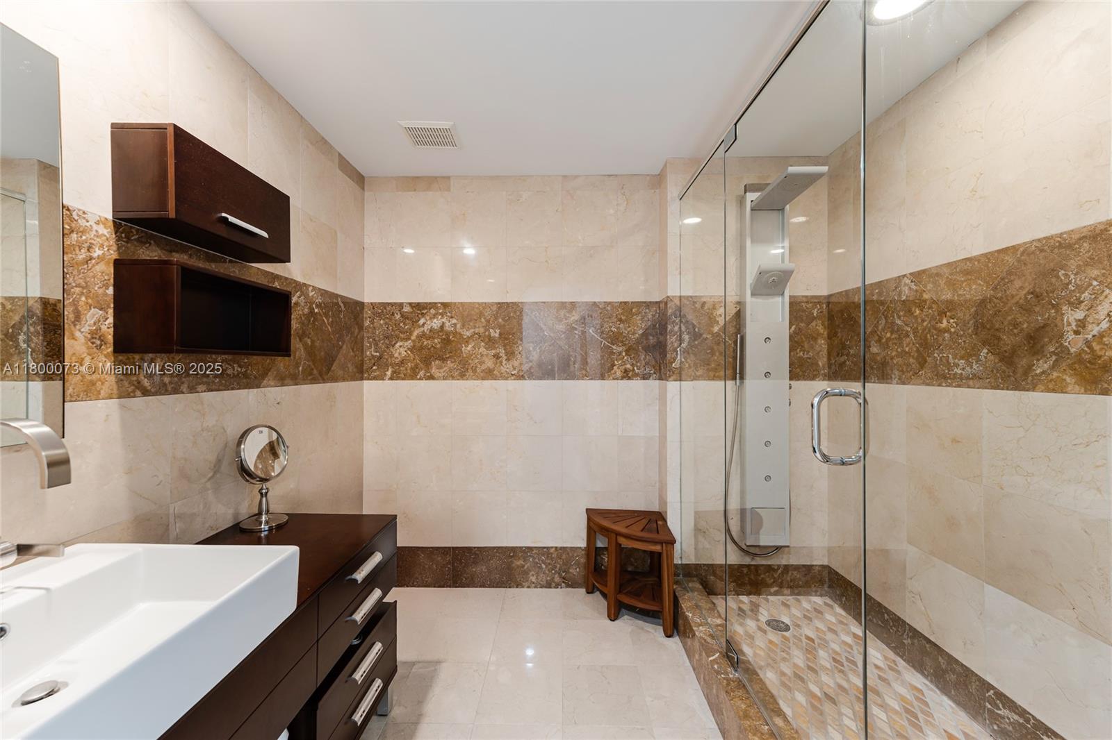 801 Brickell Key Boulevard, Unit 1911 Miami, FL 33131 - Photo 16 of 21 a bathroom with a sink a toilet and mirror