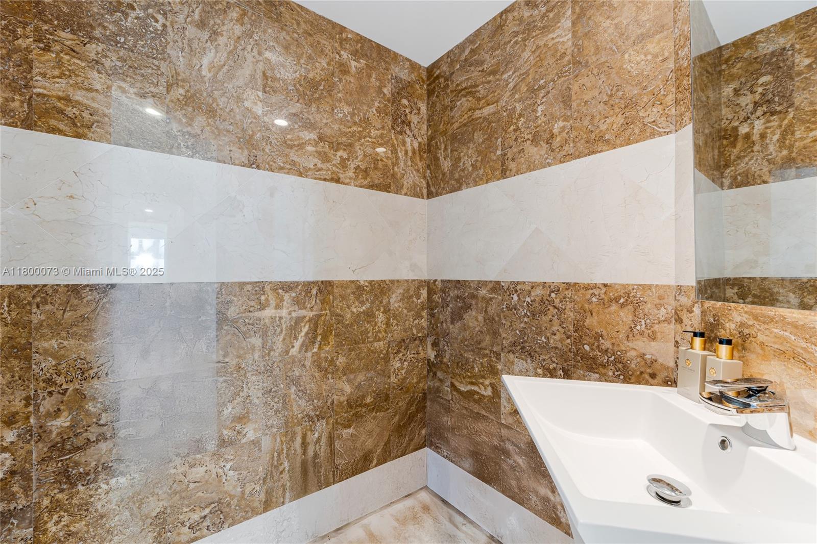 801 Brickell Key Boulevard, Unit 1911 Miami, FL 33131 - Photo 17 of 21 a bathroom with a bathtub and a sink
