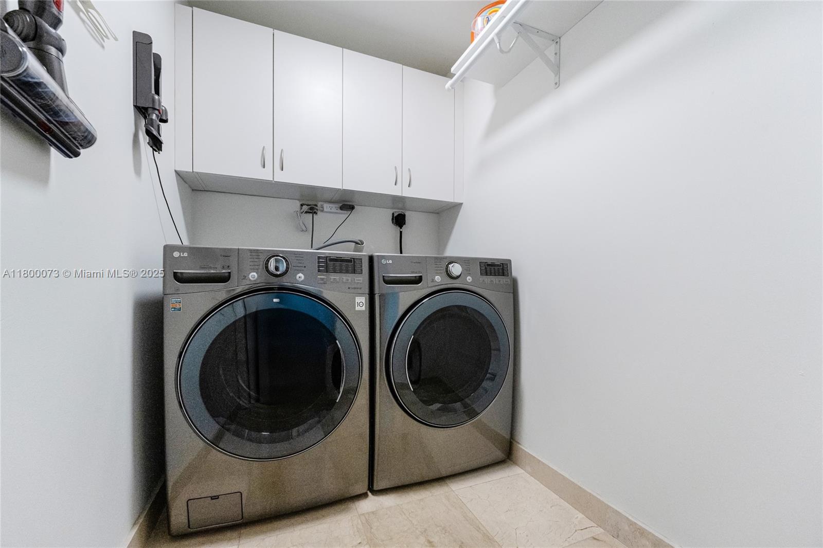 801 Brickell Key Boulevard, Unit 1911 Miami, FL 33131 - Photo 20 of 21 a utility room with dryer and washer