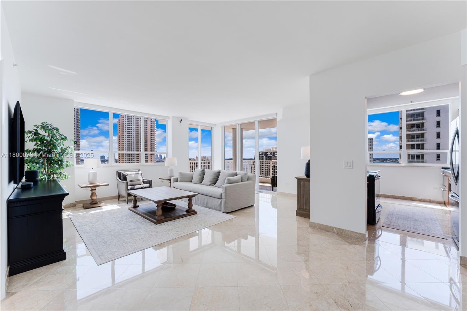 801 Brickell Key Boulevard, Unit 1911 Miami, FL 33131 - Photo 2 of 21 a living room with furniture and a large window