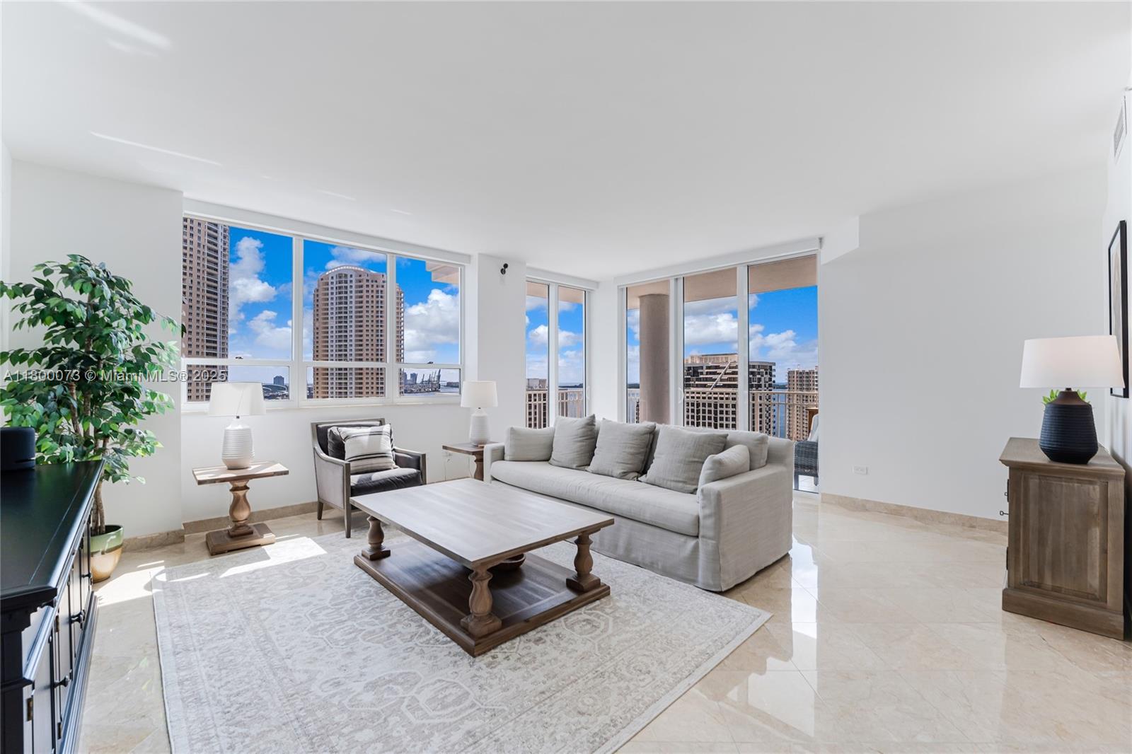 801 Brickell Key Boulevard, Unit 1911 Miami, FL 33131 - Photo 4 of 21 a living room with furniture and a potted plant