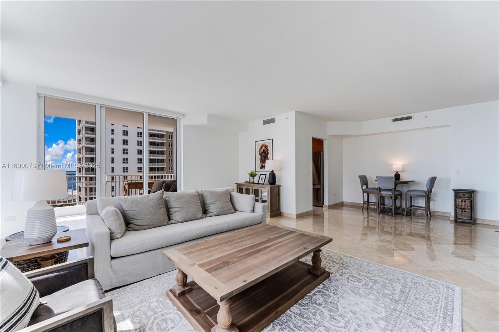 801 Brickell Key Boulevard, Unit 1911 Miami, FL 33131 - Photo 5 of 21 a living room with furniture and a large window