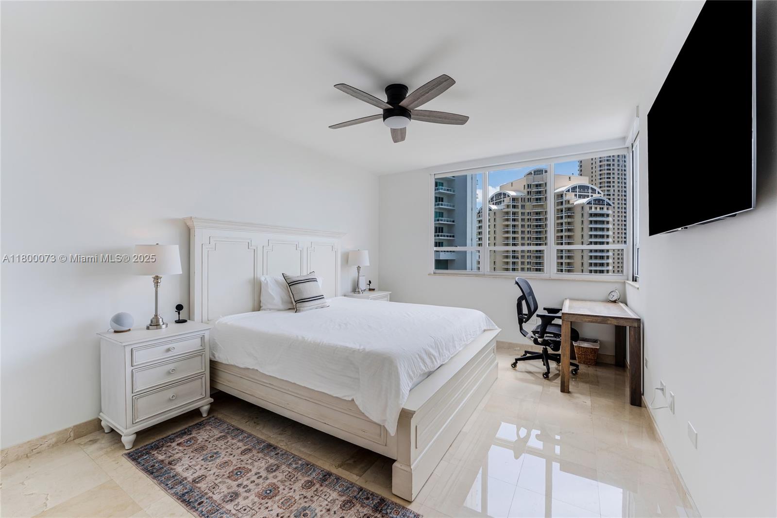 801 Brickell Key Boulevard, Unit 1911 Miami, FL 33131 - Photo 10 of 21 a bedroom with a bed and a large window
