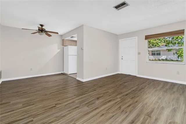 wooden floor in an empty room with a window