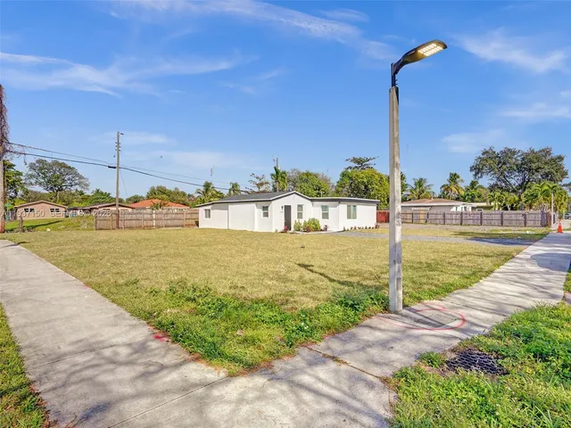 a view of a swimming pool with a yard