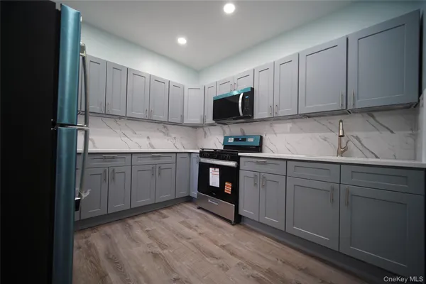 a kitchen with stainless steel appliances granite countertop a stove sink and cabinets